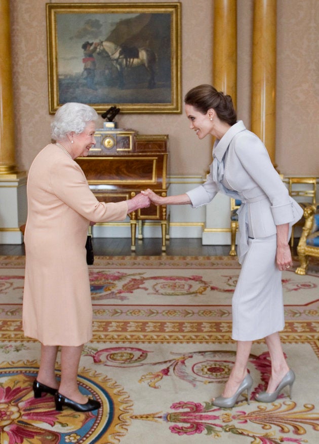 Angelina Jolie is made an honourary dame by Queen Elizabeth II at Buckingham Palace on October 10, 2014.