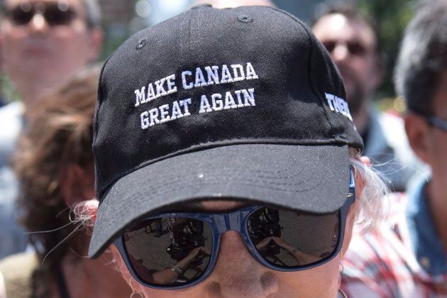 A Doug Ford supporter listens to the new Ontario premier speak outside the Ontario Legislature after a swearing in ceremony in Toronto on June 29.