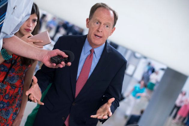 Sen. Pat Toomey, R-Pa., talks with reporters in the Capitol's Senate subway before the Senate Policy luncheons on June 19, 2018.