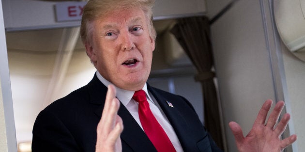 U.S. President Donald Trump speaks to the press aboard Air Force One in flight as he travels from Joint Base Andrews in Maryland, to Bedminster, New Jersey on June 29, 2018.