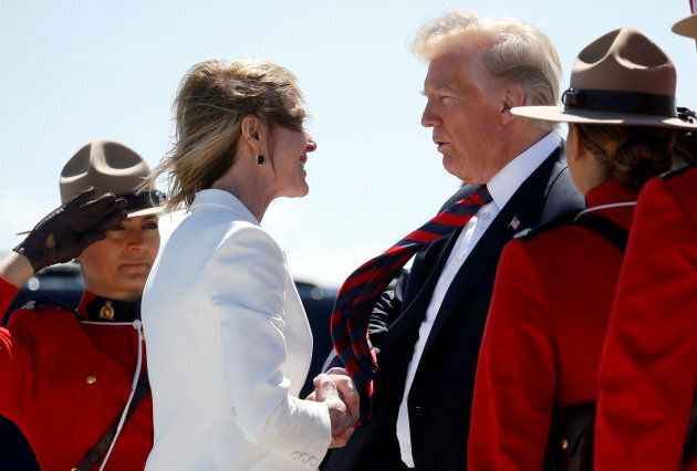 U.S. President Donald Trump is greeted by U.S. Ambassador to Canada Kelly Knight Craft as he arrives to attend the nearby G7 Summit after landing at Canadian Forces Base Bagotville in La Baie, Que., on June 8, 2018.