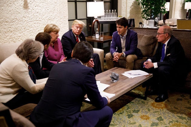 Prime Minister Justin Trudeau and G7 leaders, including U.S. President Donald Trump, pictured to Trudeau's left, hold a meeting with staff on the first day of the G7 meeting in La Malbaie, Que. on June 8, 2018.