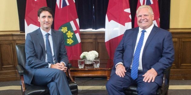 Ontario Premier Doug Ford sits with Prime Minister Justin Trudeau at the Ontario legislature in Toronto on July 5, 2018.