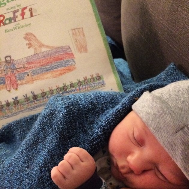 The author's newborn son enjoying "Six Little Ducks" while dozing with his mama.