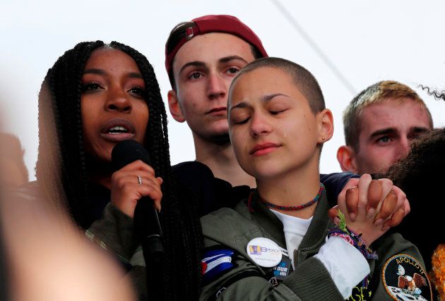 Shooting survivors Tyra Hemans (L) and Emma Gonzalez (R), from Marjory Stoneman Douglas High School in Parkland, Florida, hug as Hemans addresses the conclusion of the "March for Our Lives" event demanding gun control after recent school shootings at a rally in Washington, U.S., March 24, 2018.
