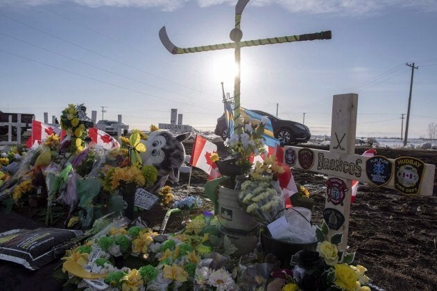 Hockey sticks, messages and other items continue to be added to a memorial at the intersection of a fatal bus crash that killed 16 members of the Humboldt Broncos hockey team last week near Tisdale, Sask. on April 14, 2018.