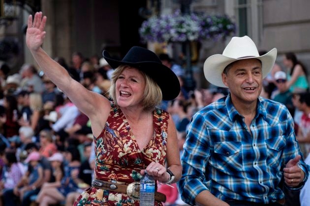 Alberta premier Rachel Notley, left, and finance minister Joe Ceci take part in the Calgary Stampede parade on July 6, 2018.