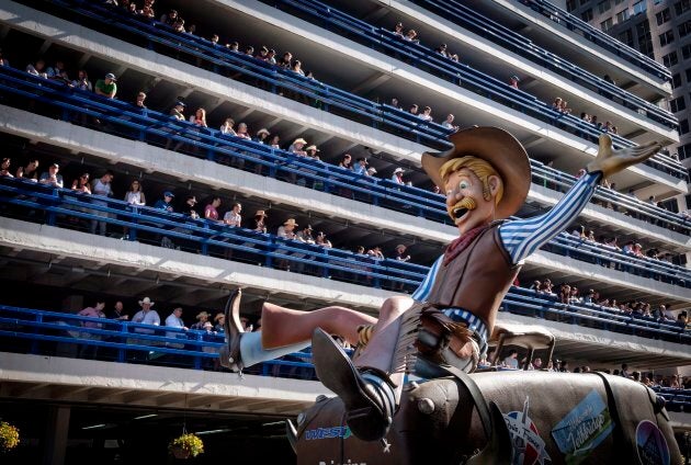 A parade float pass spectators lining a parkade during the Calgary Stampede on July 6, 2018.