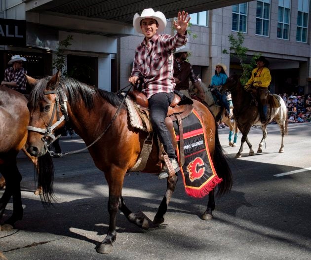 Johnny Gaudreau of the Calgary Flames waves as he rides during the Calgary Stampede parade on July 6, 2018.