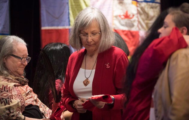 Chief Commissioner Marion Buller presents eagle feathers to a witness following her testimony during the National Inquiry of Missing and Murdered Indigenous Women and Girls in Richmond, B.C. on April, 6, 2018.