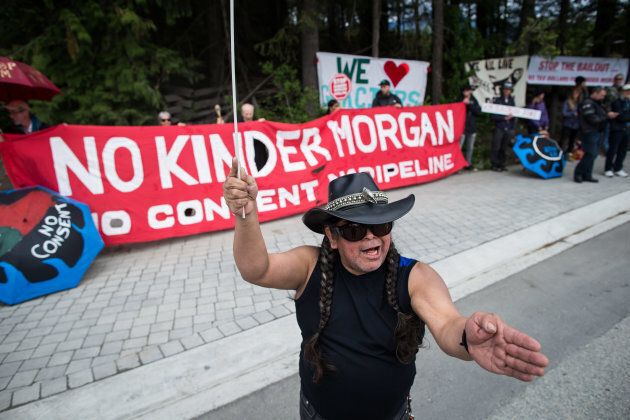 Demonstrators hold signs and chant during a protest against the Kinder Morgan Trans Mountain Pipeline expansion, outside of the G7 finance ministers and central bank governors meeting in Whistler, B.C., on June 2, 2018.