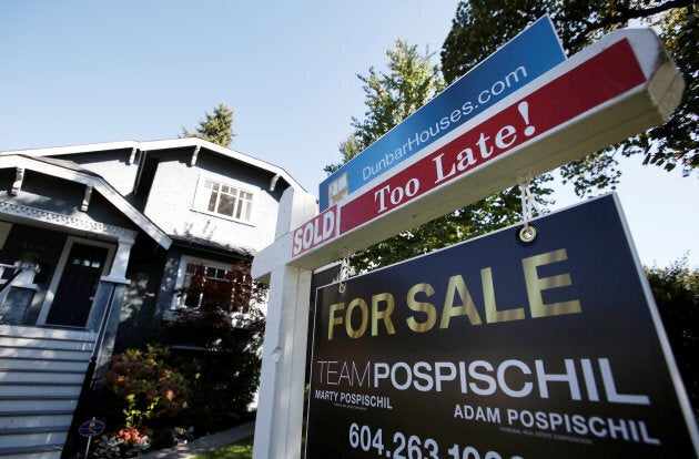 A real estate for sale sign is pictured in front of a home in Vancouver, B.C., on Sept. 22, 2016.