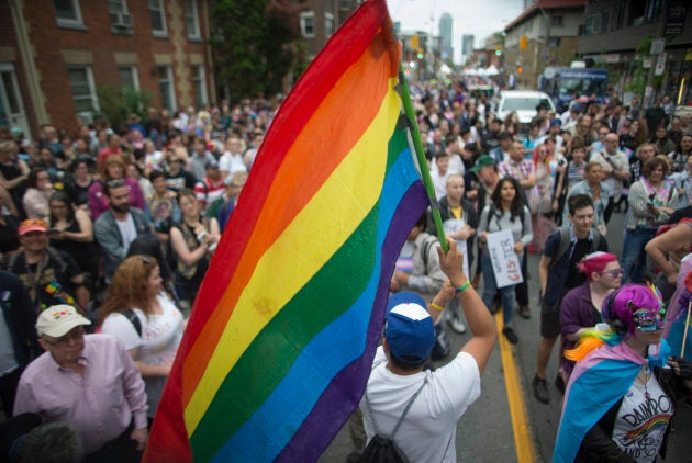 A man holds a Pride flag near the stage in Toronto on June 22, 2018.