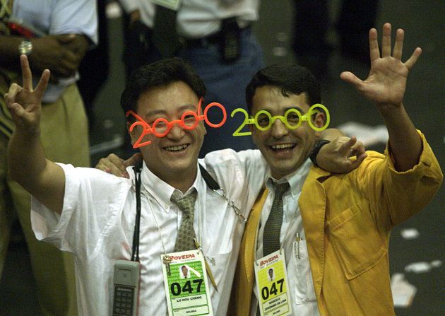 Stock traders wearing Y2K glasses celebrate at the last trading day 1999, where closed up with the historic record of 17,091 points, in the floor of Sao Paulo's Stock Exchange on Dec. 30, 1999.