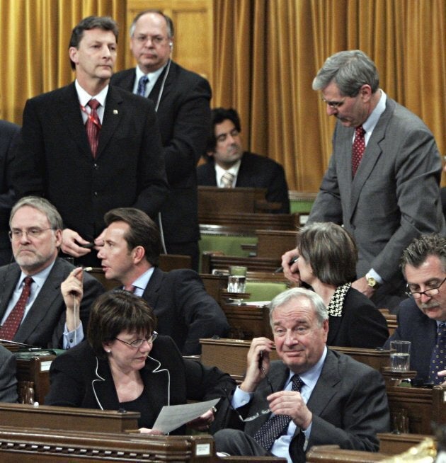 Deputy Prime Minister Anne McLellan and Prime Minister Paul Martin sit in the front row as Liberal MPs John McKay, Paul Szabo and Roy Cullen (standing left to right) vote with Conservative Party leader Stephen Harpers motion on same sex marriage legislation in the House of Commons in Ottawa on April 12, 2005. MPs voted down the Conservative motion that would have derailed the minority Liberal government's same-sex marriage bill.