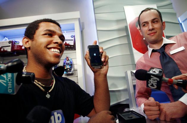 Jordon Brown, the first buyer of the new Apple iPhone 3G in Toronto, shows off his phone July 11, 2008.