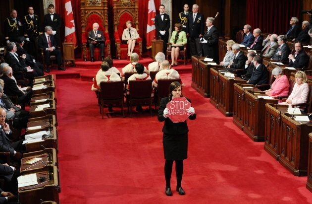 Page Brigette DePape stands in the middle of the floor of the Senate as Governor General David Johnston delivers the Speech from the Throne in the Senate Chamber on Parliament Hill in Ottawa on June 3, 2011.
