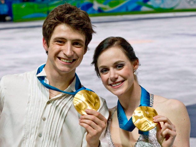 Tessa Virtue and Scott Moir pose with their gold medals during victory ceremonies on Feb. 22, 2010 at the Vancouver Olympic Winter Games.