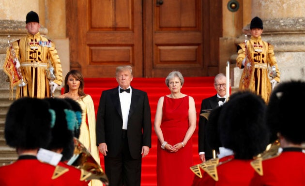 British Prime Minister Theresa May and her husband Philip stand together with U.S. President Donald Trump and first Lady Melania Trump at the entrance to Blenheim Palace, where they are attending a dinner with specially invited guests and business leaders, near Oxford, Britain on July 12, 2018.