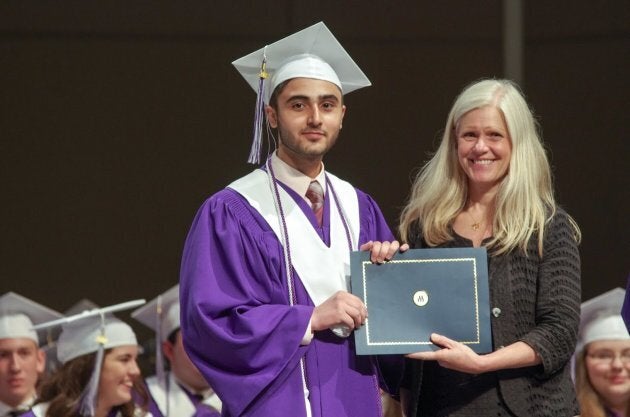 Yasser Al Asmi receiving the Roméo LeBlanc scholarship from the mayor of Moncton, Dawn Arnold, during his graduation ceremony.