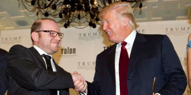Donald Trump, right, and owner Alex Shnaider shake hands hands after the ceremonial ribbon cutting for the Trump International Hotel in Toronto on April 16, 2012.