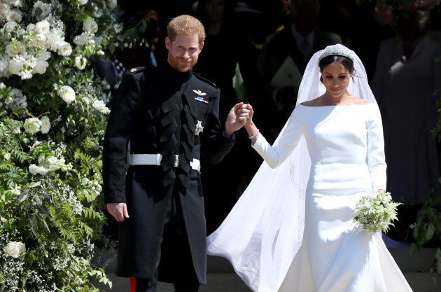 Prince Harry and Meghan Markle leave St George's Chapel in Windsor Castle after their wedding. Her wedding dress, designed by Clare Waight Keller for Givenchy, has a bateau neckline.