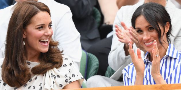 Catherine, Duchess of Cambridge, and Meghan, Duchess of Sussex, attend day twelve of the Wimbledon Tennis Championships at the All England Lawn Tennis and Croquet Club on Saturday in London.