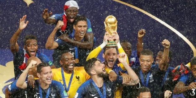 France's Hugo Lloris lifts the trophy as his team celebrates winning the World Cup in Moscow on Sunday night.