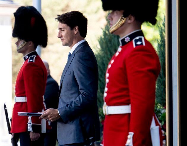 Prime Minister Justin Trudeau passes members of the Ceremonial Guard as he arrives for a press conference following a swearing-in ceremony at Rideau Hall in Ottawa on July 18, 2018.