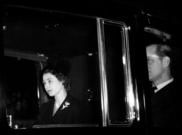 Queen Elizabeth II returns to Clarence House, London, with the Duke of Edinburgh from London Airport after the sudden death of her father, King George VI. She succeeded the King on his death a day earlier.