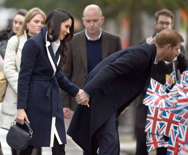 Prince Harry and Meghan Markle hold hands as they visit Millennium Point in Birmingham, England on March 8, 2018.