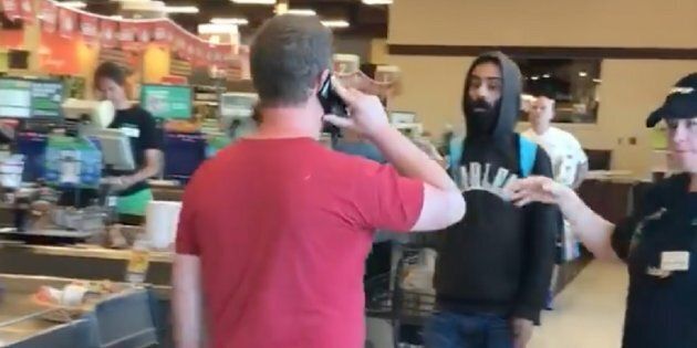 The man in the red, left, was warned by police after allegedly pushing and verbally accosting another shopper at Sobeys in London, Ont. on Wednesday.