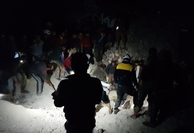 Civil defence team members stage rescue operation after war planes belonging to the Assad regime targeted a cave where people had been sheltering to protect themselves from the attacks at the Maar Zita village in Idlib, Syria on May 9, 2018.