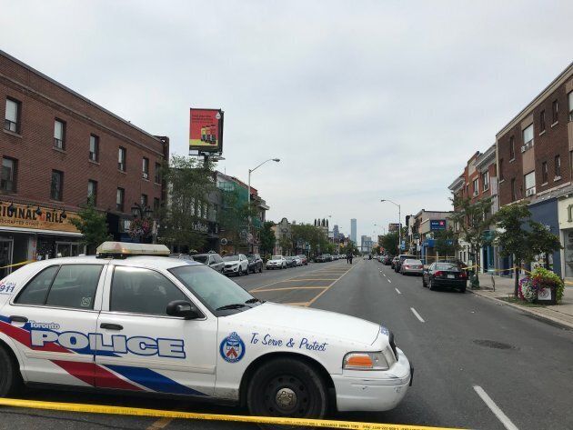 A Toronto police vehicle blocks access to Danforth Avenue, where a mass shooting killed two victims and injured 13 others. The gunman is also dead.