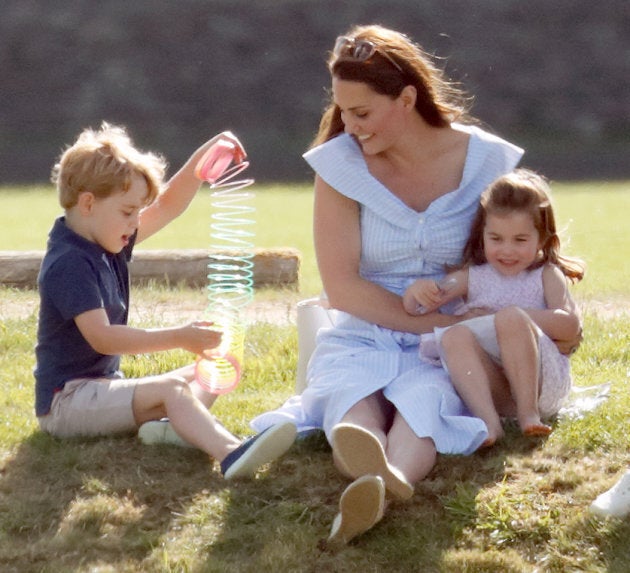 Catherine, Duchess of Cambridge, plays with Prince George and Princess Charlotte while attending the Maserati Royal Charity Polo Trophy at the Beaufort Polo Club on June 10, 2018 in Gloucester, England.