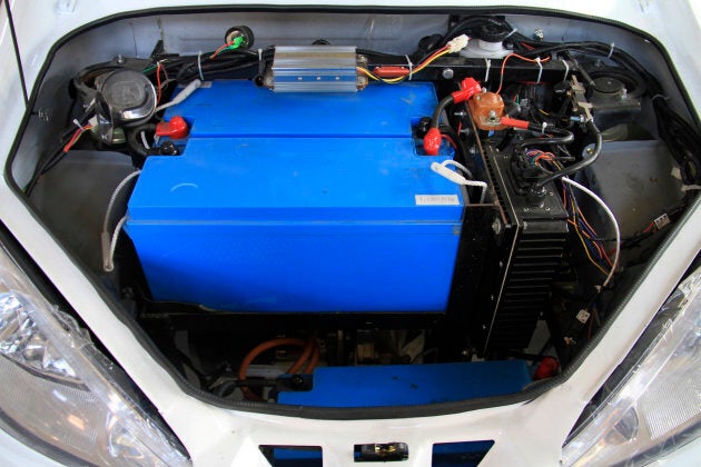 Batteries and other car components are installed on an electric car at an assembly line at a factory in Weihai, Shandong province, China.