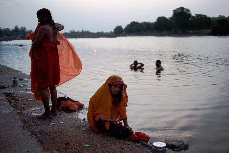 Indian women wash their saris on the banks of the Betwa River in Orchha in the state of Madhya Pradesh on July 5, 2015.