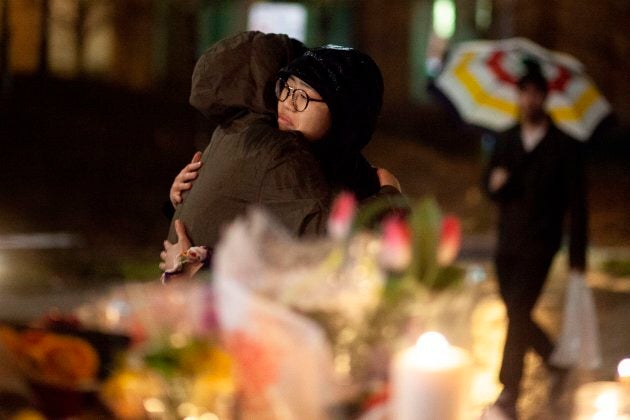 Mourners share a hug during a candle light vigil near the site of the deadly Toronto van attack in April.