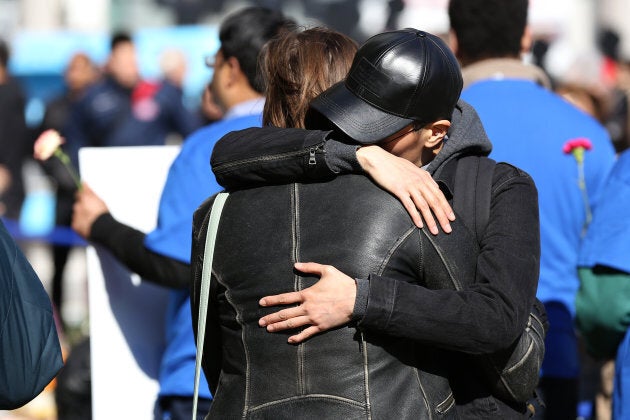 Two people hug at a makeshift memorial in Mel Lastman Square in Toronto for the victims of the van attack before a vigil on April 29, 2018.