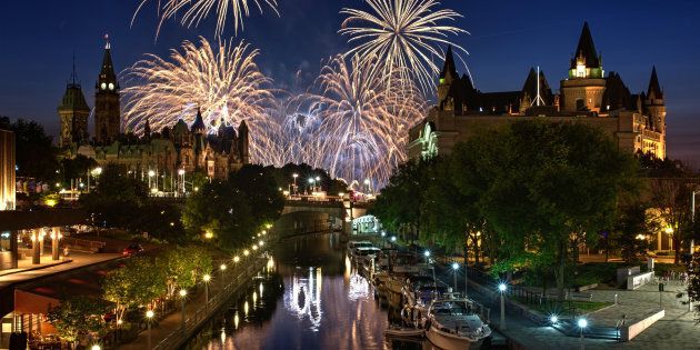 Fireworks are visible from the Rideau Canal in Ottawa, with Parliament Hill and the Fairmont Chateau Laurier in the background. Canada's economy surprised many experts with an unusually strong showing in May.