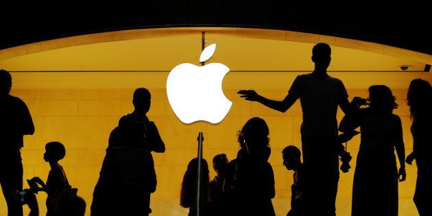 Customers walk past an Apple logo inside an Apple store at Grand Central Station, New York, N.Y., Aug. 1. Apple Inc. became the first US$1 trillion publicly listed company on Thursday.