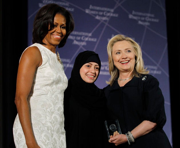 U.S. Secretary of State Hillary Clinton and First Lady Michelle Obama congratulate Samar Badawi during the State Department's 2012 International Women of Courage award winners ceremony in Washington on March 8, 2012.