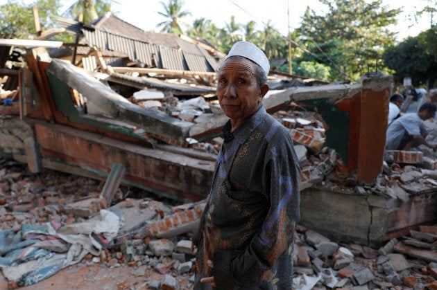 A villager walks through a collapsed house after an earthquake hit Lombok Island in Pemenang, Indonesia on Monday.