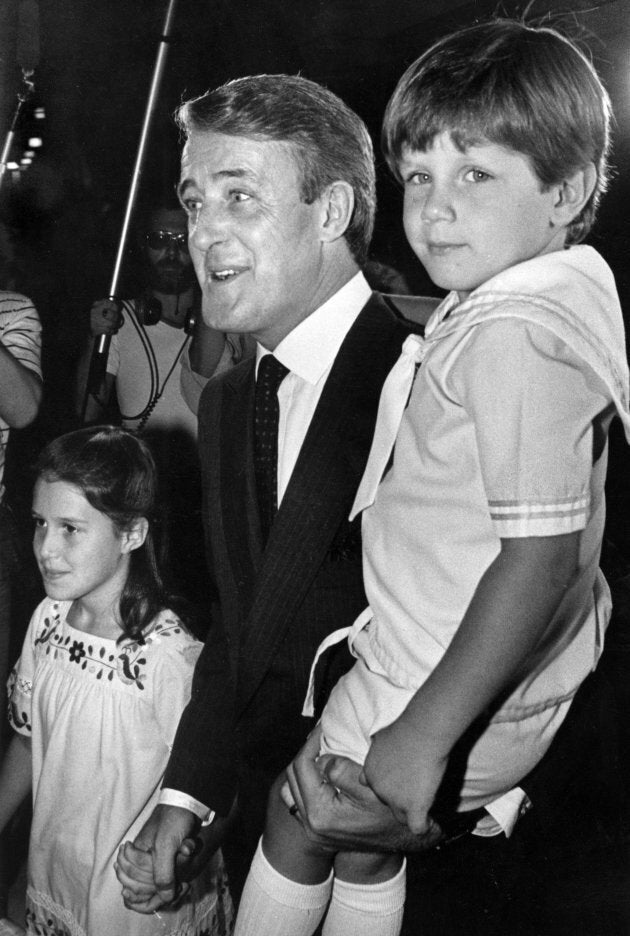 Brian Mulroney carries his son Mark as he makes his way to a swearing-in ceremony with his daughter Caroline in this Sept. 6, 1983 file photo in Ottawa.