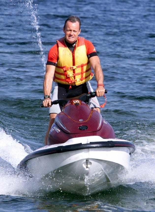 Canadian Alliance leader Stockwell Day arrives at a news conference on a Jet Ski on Okanagan Lake in Penticton, B.C. on Sept. 12, 2000.