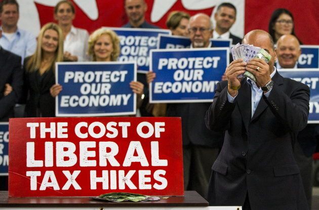 Dino Ari, a local restaurant owner, takes part in a skit as he illustrates how much the Conservatives say the Liberals will cost small business owners in taxes, at then-Conservative leader Stephen Harper's campaign rally in Etobicoke on Oct. 13, 2015.