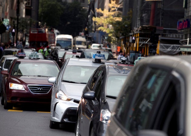 Taxis block the streets for their protest against Uber in Montreal on October 5, 2016.