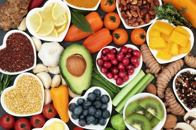 Healthy food with fresh fruit, vegetables, pulses, herbs, spices, nuts and grains and pulses.