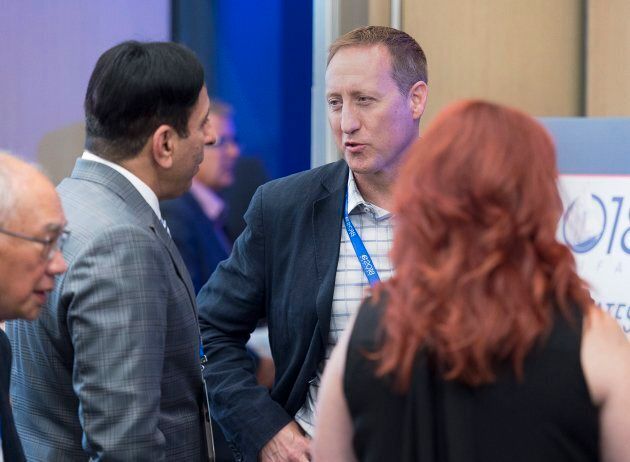 Former Conservative cabinet minister Peter MacKay chats with delegates at the Conservative Party of Canada national policy convention in Halifax on Friday.