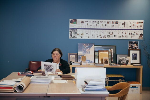 Nancy Hurn leafs through binders of photos from Anglican residential schools. Hurn help families who have lost relatives somewhere in the residential school system